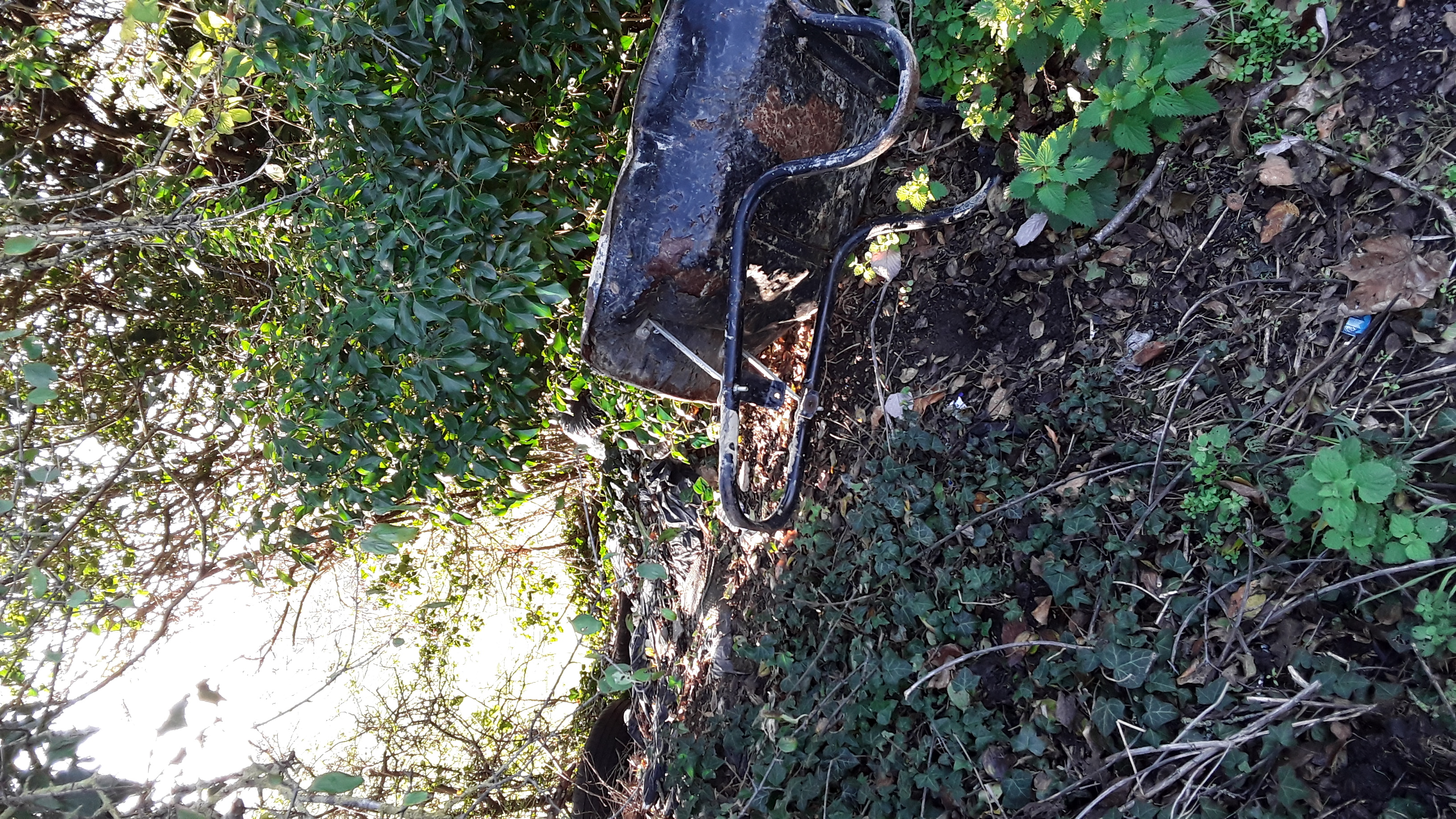 a discarded wheelbarrow at the layby